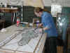 Soldering stained glass panels in the studio